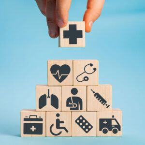 Zehn W&uuml;rfel sind in Form einer Pyramide aufgestellt. Darauf sind medizinische Symbole zu sehen.